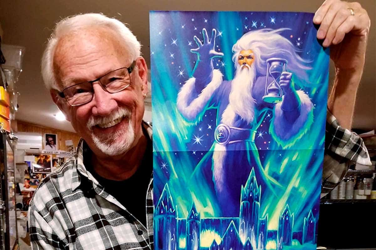 Greg Hildebrandt: A Special Art Exhibit - Greg holding artwork