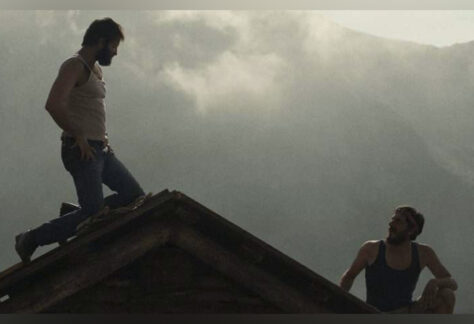 Film: The Eight Mountains graphic with two men on a mountaintop